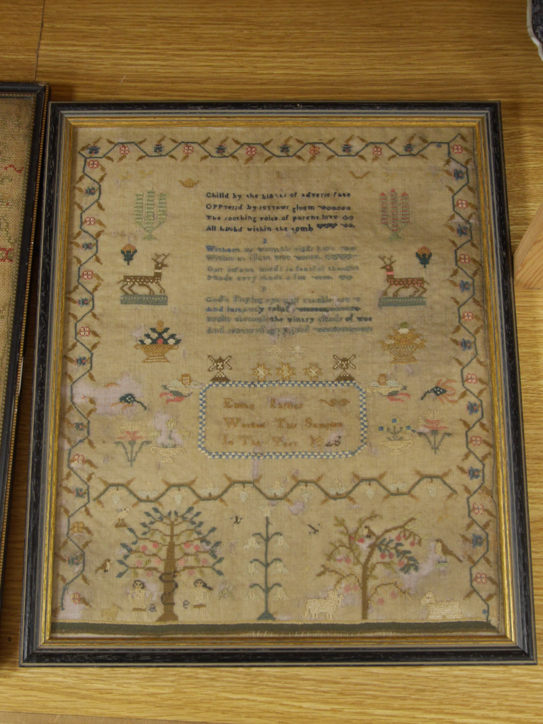 Three framed early to mid 19th century samplers, including an 1828 Adam and Eve sampler embroidered by Emma Parker, worked with a floral border with various spot motifs and verse, together with an alphabet sampler by Jan